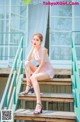 A woman sitting on the steps of a building.